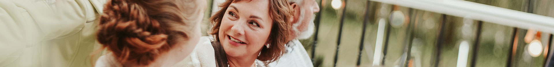 woman smiling at dinner party table